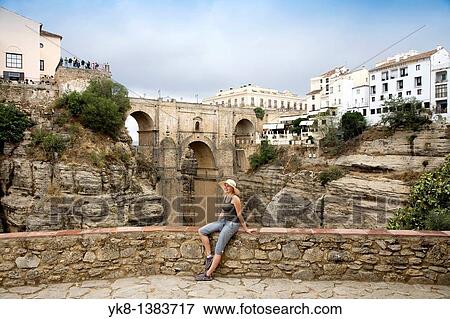 Woman Sitting on Stone Fence by Ronda`s New Bridge, Andalucia, Spain View Large Photo Image Stock Photo - Woman Sitting on Stone Fence by Ronda`s New Bridge, Andalucia, Spain. Fotosearch