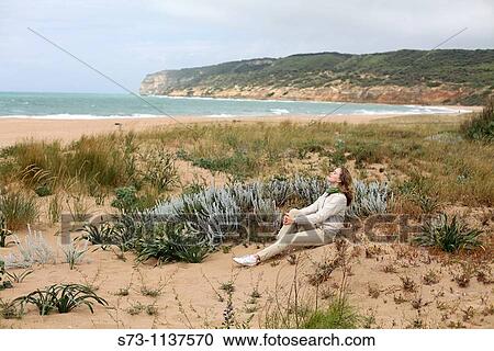 Woman sitting on the beach, Barbate, Cadiz, Andalusia, Spain View Large Photo Image Stock Image - Woman sitting on the beach, Barbate, Cadiz, Andalusia, Spain. Fotosearch