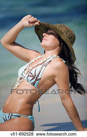 Woman sitting on the beach View Large Photo Image Stock Photo - Woman sitting on the beach. Fotosearch