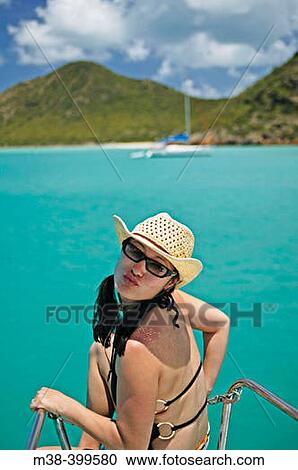 Woman sitting on the front of a catamaran giving a kiss to the camera View Large Photo Image Stock Image - Woman sitting on the front of a catamaran giving a kiss to the camera. Fotosearch