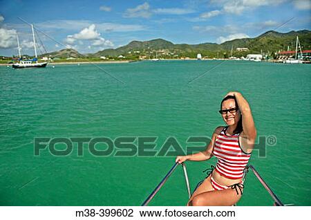 Woman sitting on the front of a catamaran in Antigua View Large Photo Image Stock Image - Woman sitting on the front of a catamaran in Antigua. Fotosearch