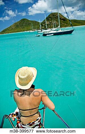 Woman sitting on the front of a catamaran, sailing in Antigua View Large Photo Image Stock Photo - Woman sitting on the front of a catamaran, sailing in Antigua. Fotosearch