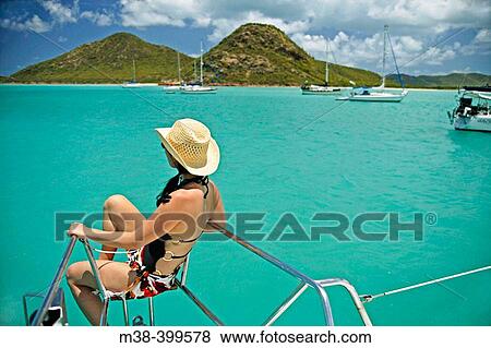Woman sitting on the front of a catamaran, sailing in Antigua View Large Photo Image Stock Photo - Woman sitting on the front of a catamaran, sailing in Antigua. Fotosearch