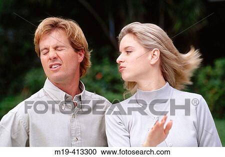 Stock Image - woman slapping a man in the face. Fotosearch
