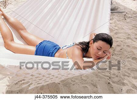 Woman sleeping in a hammock at the beach View Large Photo Image Stock Photography - Woman sleeping in a hammock at the beach. Fotosearch