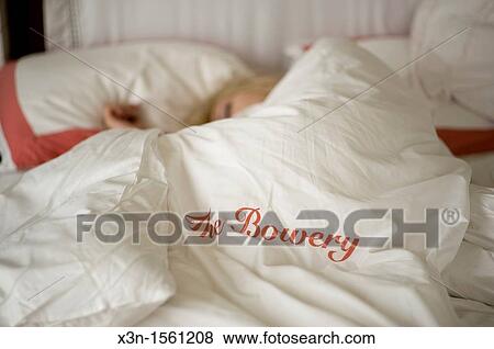 Woman sleeping in bed, Bowery Hotel, New York City NY View Large Photo Image Stock Photo - Woman sleeping in bed, Bowery Hotel, New York City NY. Fotosearch