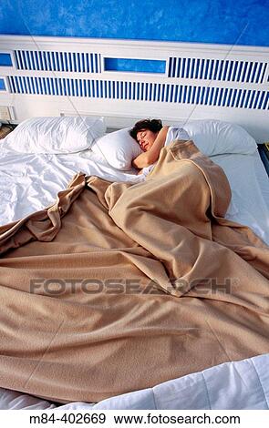 Woman sleeping in king size bed View Large Photo Image Stock Photo - Woman sleeping in king size bed. Fotosearch