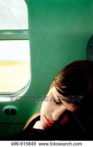 Woman sleeping in train View Large Photo Image Stock Photo - Woman sleeping in train. Fotosearch