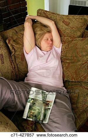 Stock Photo - Woman sleeping on couch exhausted. Fotosearch