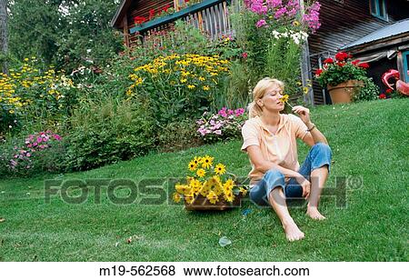 woman smelling a flower View Large Photo Image Stock Photo - woman smelling a flower. Fotosearch