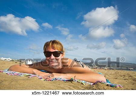 Woman smiling on the beach View Large Photo Image Stock Photo - Woman smiling on the beach. Fotosearch