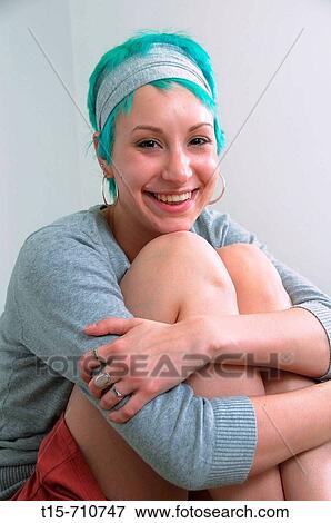 Stock Photo - woman smiling sitting on bed. Fotosearch