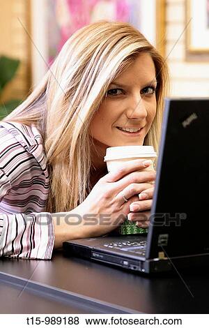 Woman smiling using computer View Large Photo Image Stock Photo - Woman smiling using computer. Fotosearch