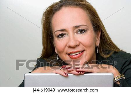 Woman smiling with hands on laptop screen View Large Photo Image Stock Photo - Woman smiling with hands on laptop screen. Fotosearch