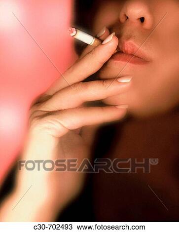 Stock Image - Woman smoking cigarette.. Fotosearch