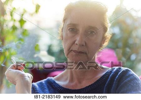Woman smoking quietly in the garden, Javea, Alicante, Valencia, Spain. View Large Photo Image Stock Photo - Woman smoking quietly in the garden, Javea, Alicante, Valencia, Spain.. Fotosearch
