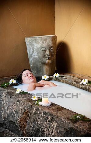 Woman soaking in a milk bath, Ayurveda treatment, Negombo, Sri Lanka. View Large Photo Image Picture - Woman soaking in a milk bath, Ayurveda treatment, Negombo, Sri Lanka.. Fotosearch