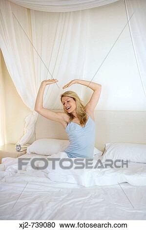 Woman sretching on the bed happy View Large Photo Image Stock Image - Woman sretching on the bed happy. Fotosearch