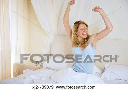 Woman sretching on the bed happy View Large Photo Image Stock Photo - Woman sretching on the bed happy. Fotosearch