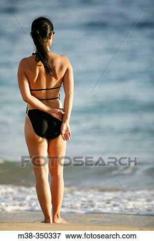 Woman standing on a beach in Kauai. USA View Large Photo Image Stock Photo - Woman standing on a beach in Kauai. USA. Fotosearch