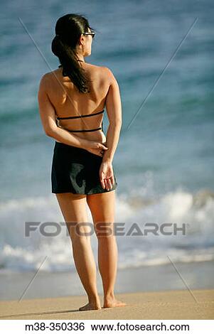 Woman standing on a beach in Kauai. USA View Large Photo Image Stock Photograph - Woman standing on a beach in Kauai. USA. Fotosearch
