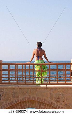 Woman Standing on Bridge in Holiday Resort in Swimming Costume, Red Sea, Egypt View Large Photo Image Picture - Woman Standing on Bridge in Holiday Resort in Swimming Costume, Red Sea, Egypt. Fotosearch
