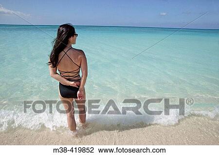 Woman standing on Seven Mile Beach in Grand Cayman Island. Cayman Islands. Caribbean. UK View Large Photo Image Stock Image - Woman standing on Seven Mile Beach in Grand Cayman Island. Cayman Islands. Caribbean. UK. Fotosearch