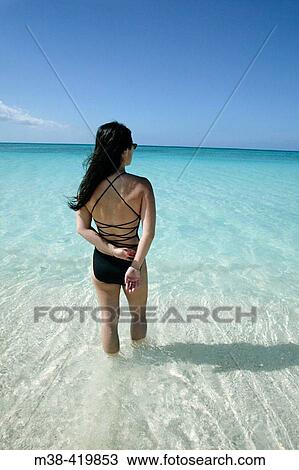 Woman standing on Seven Mile Beach in Grand Cayman Island. Taken December 2004. View Large Photo Image Stock Image - Woman standing on Seven Mile Beach in Grand Cayman Island. Taken December 2004.. Fotosearch
