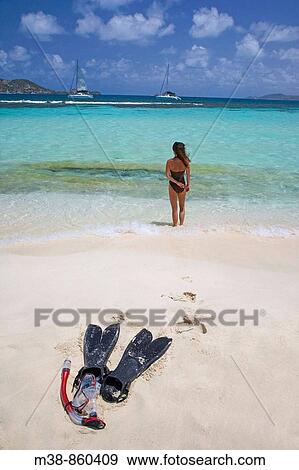 Woman standing on the beach with snorkel gear in foreground Mopion, St Vincent and the Grenadines View Large Photo Image Stock Photo - Woman standing on the beach with snorkel gear in foreground Mopion, St Vincent and the Grenadines. Fotosearch