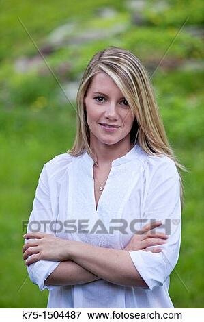 Stock Photo - Woman standing with her arms crossed. Fotosearch