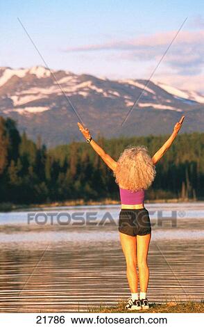 Woman stretching. Alaska. USA View Large Photo Image Stock Photograph - Woman stretching. Alaska. USA. Fotosearch