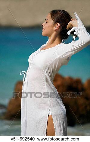 Woman stretching and breathing by the sea View Large Photo Image Stock Image - Woman stretching and breathing by the sea. Fotosearch