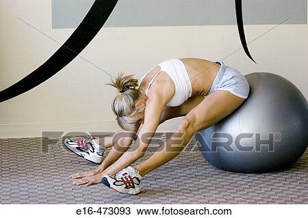Woman stretching at gym View Large Photo Image Stock Image - Woman stretching at gym. Fotosearch