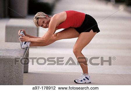 Stock Image - Woman stretching before exercise. Fotosearch