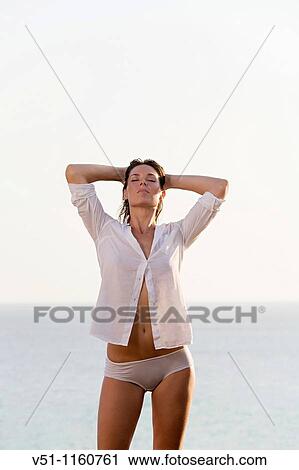 Woman stretching by the sea View Large Photo Image Stock Image - Woman stretching by the sea. Fotosearch
