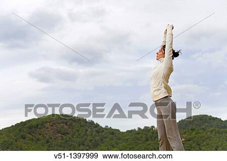 Woman stretching in a natural environment in Ibiza View Large Photo Image Stock Photo - Woman stretching in a natural environment in Ibiza. Fotosearch