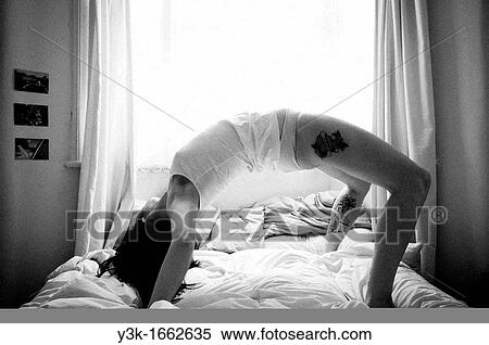 Woman stretching in bed. London. View Large Photo Image Stock Photography - Woman stretching in bed. London.. Fotosearch
