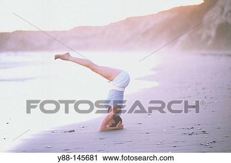 Woman stretching on the beach View Large Photo Image Stock Image - Woman stretching on the beach. Fotosearch