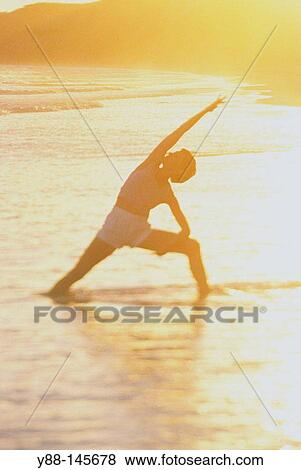 Woman stretching on the beach View Large Photo Image Stock Photo - Woman stretching on the beach. Fotosearch