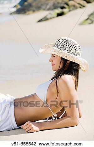 Woman sunbathing by the sea View Large Photo Image Stock Image - Woman sunbathing by the sea. Fotosearch