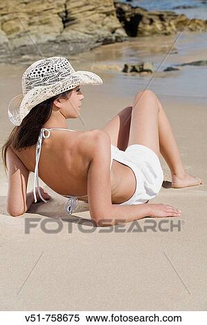 Woman sunbathing by the sea View Large Photo Image Stock Photography - Woman sunbathing by the sea. Fotosearch