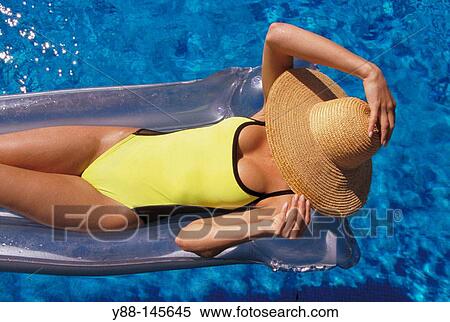 Woman sunbathing on airbed View Large Photo Image Stock Photography - Woman sunbathing on airbed. Fotosearch