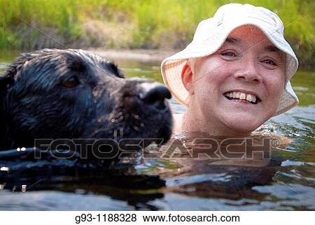 woman swimming in river with dog View Large Photo Image Stock Photo - woman swimming in river with dog. Fotosearch