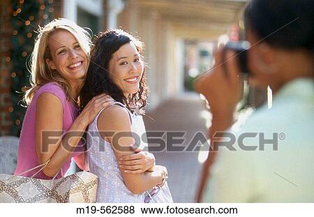 woman takes her girlfriend's picture View Large Photo Image Stock Photo - woman takes her girlfriend's picture. Fotosearch