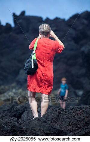 Woman taking a picture in the coast. Sao Miguel Island, Azores, Portugal. View Large Photo Image Stock Photography - Woman taking a picture in the coast. Sao Miguel Island, Azores, Portugal.. Fotosearch