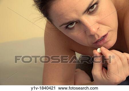 Woman taking a pill View Large Photo Image Stock Image - Woman taking a pill. Fotosearch