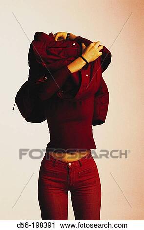 Woman taking off her jacket View Large Photo Image Stock Image - Woman taking off her jacket. Fotosearch