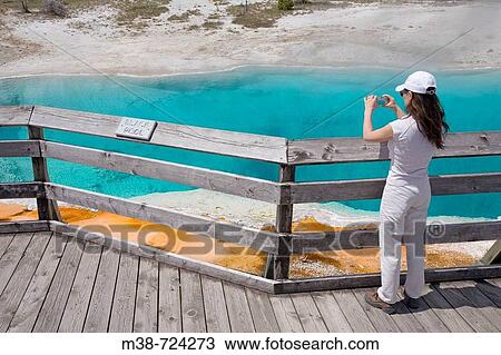 Woman taking photo of the Black Pool, Yellowstone National Park, Wyoming, USA View Large Photo Image Stock Image - Woman taking photo of the Black Pool, Yellowstone National Park, Wyoming, USA. Fotosearch