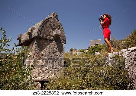 Woman taking photos of the ancient lycian tombs, Ucagiz, Antalya Region, Turkish Riviera, Turkey, Europe. View Large Photo Image Stock Image - Woman taking photos of the ancient lycian tombs, Ucagiz, Antalya Region, Turkish Riviera, Turkey, Europe.. Fotosearch
