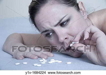 Woman taking several pills View Large Photo Image Picture - Woman taking several pills. Fotosearch